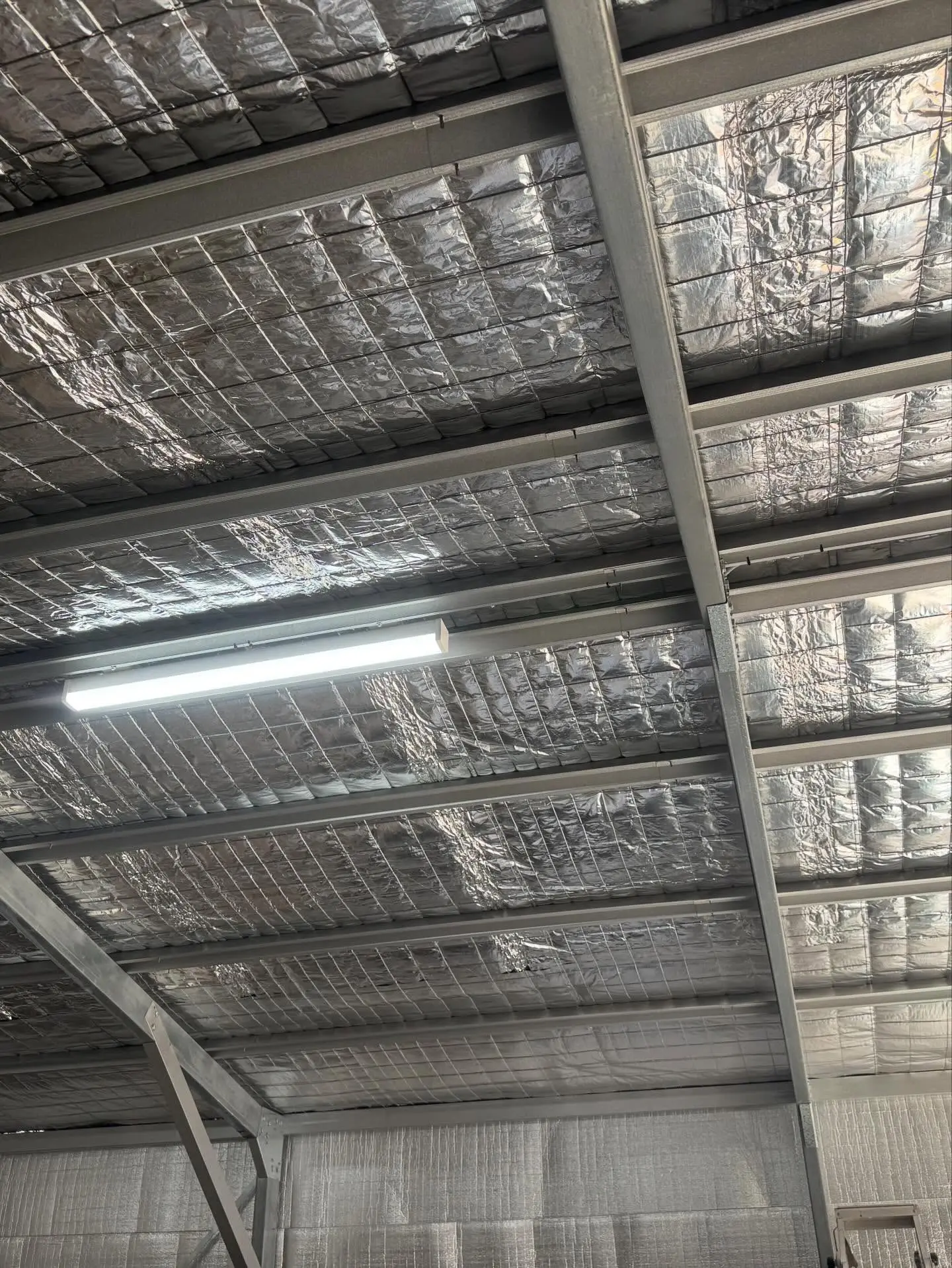 LED batten light installed on an insulated shed ceiling during a lighting installation in Wagga Wagga