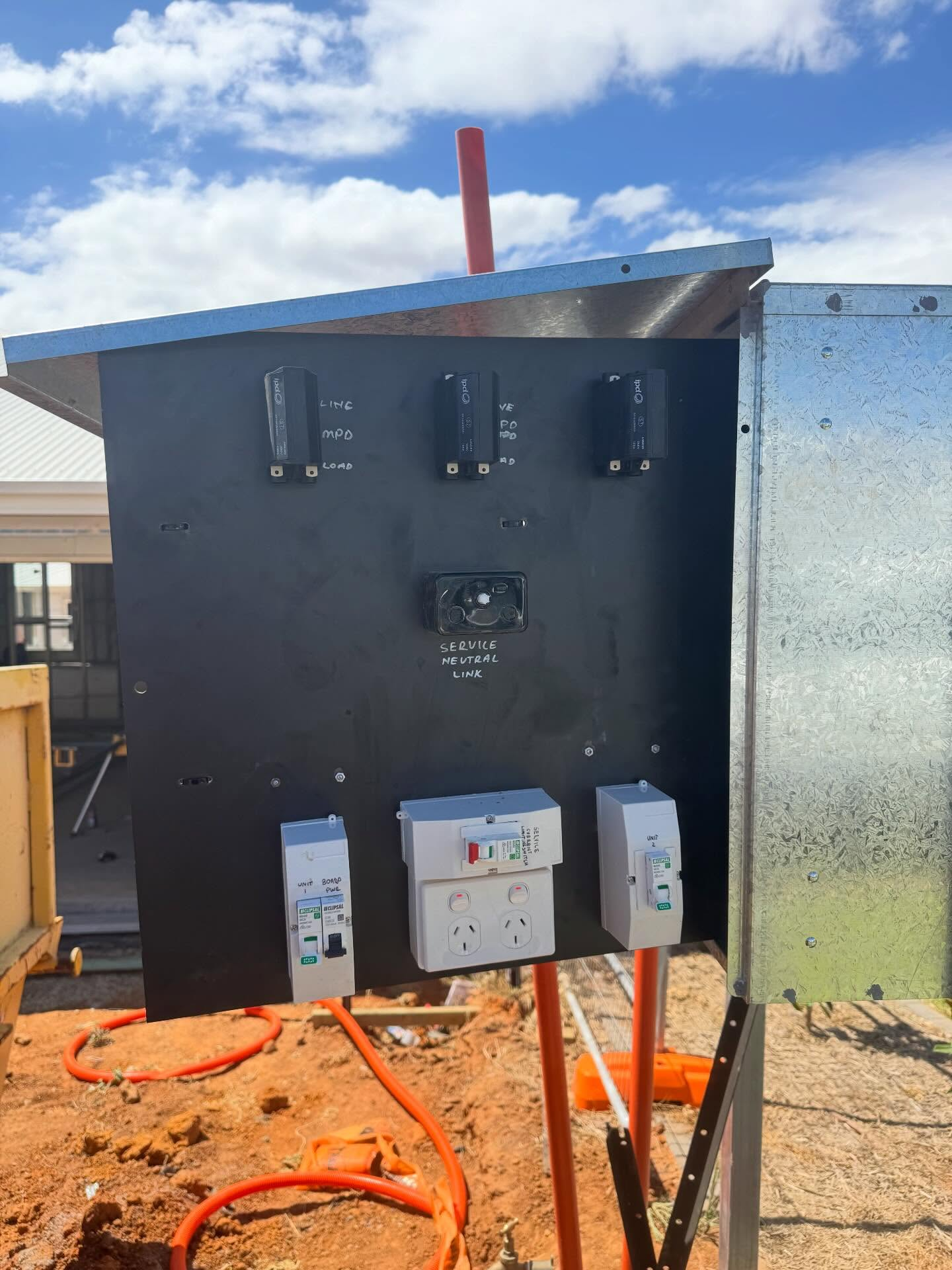 Commercial electrician's site meter box with labelled circuit breakers and power outlets on a Wagga Wagga worksite